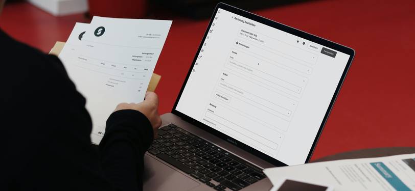 A writer or researcher analyzing a document on a computer screen, surrounded by notes and analytics charts, symbolizing advanced NLP and text analysis