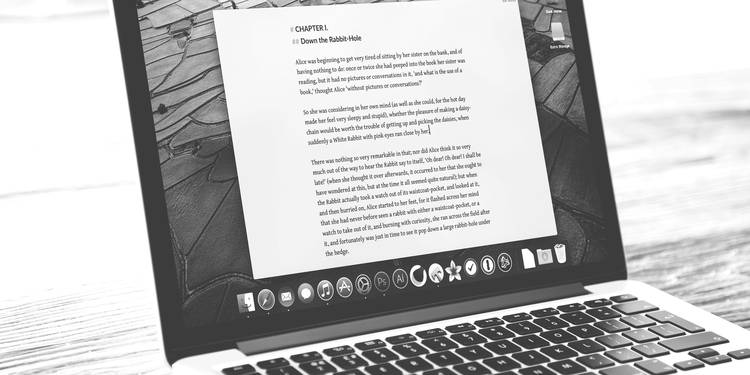 A focused writer or content creator reviewing and editing text on a laptop, surrounded by books and notes—symbolizing online readability, content clarity, and digital writing