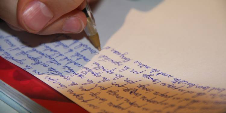 A writer reviewing and editing a manuscript at a desk, focusing on paragraph structure and formatting for an essay or article