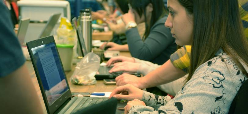 A group of people using a laptop to count letters and characters online, illustrating real-time text analysis for writers, students, and professionals