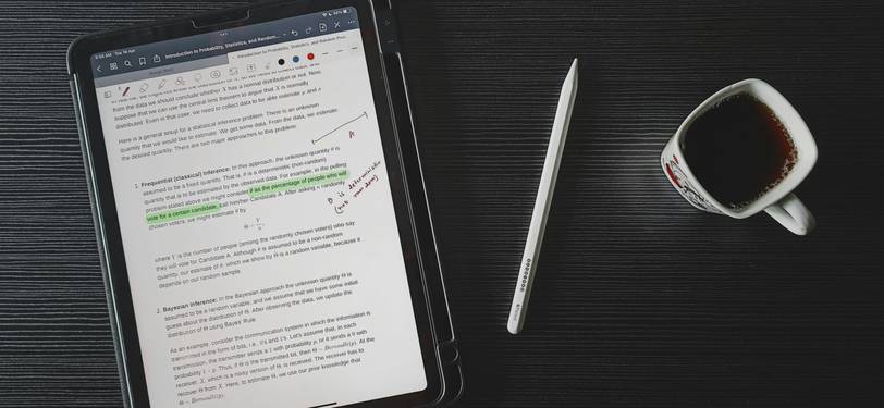 Professional writer analyzing text on laptop in modern workspace, using an online text analysis suite for writing improvement